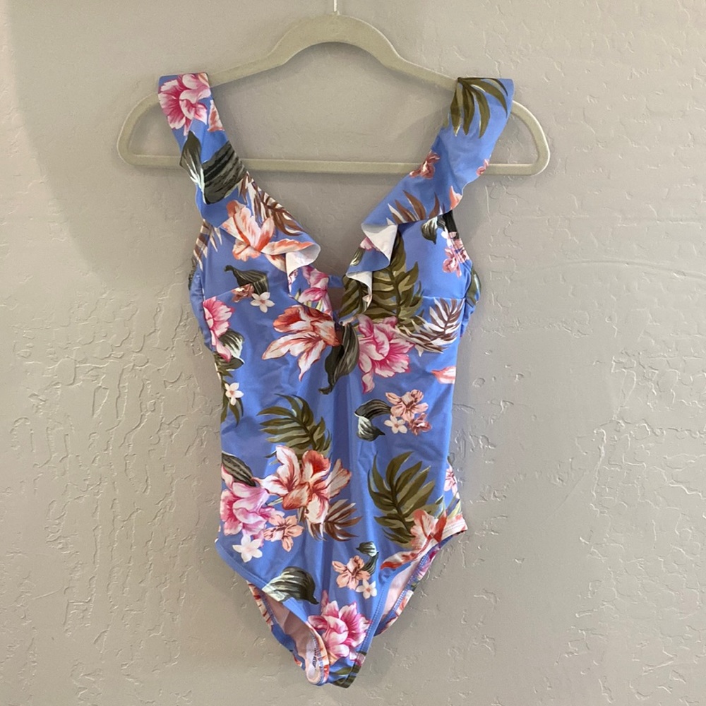 Kona Sol One piece swimsuit. Blue background with floral print